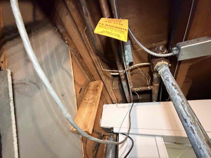 Responded to service call for boiler leaking onto floor. Upon inspection, identified active water leak in boiler piping system located in basement utility area. Documented existing plumbing configuration including copper supply lines, galvanized piping, and associated valve assemblies showing signs of age and oxidation. Photographed leak source and surrounding infrastructure for service records and recommended appropriate repairs to resolve water discharge issue.