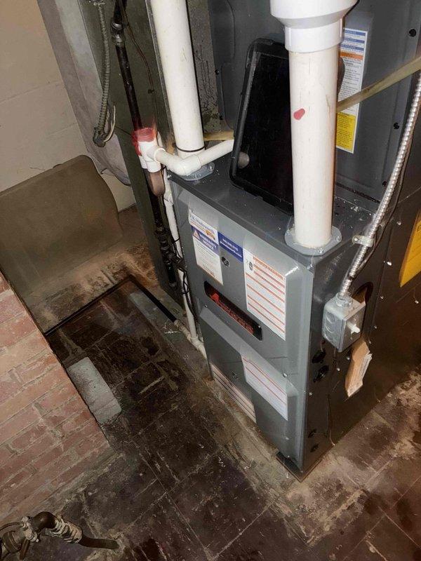 Completed scheduled heating maintenance on residential forced-air furnace system. Performed comprehensive system inspection including visual examination of unit condition, ductwork connections, and PVC venting configuration. Replaced dirty air filter with new 16x25x1 pleated filter to restore proper airflow and system efficiency. Verified all manufacturer specifications and safety labels were intact and legible on unit panels. Documented existing floor staining around equipment base for homeowner awareness. System operational and functioning within normal parameters upon completion of maintenance service.
