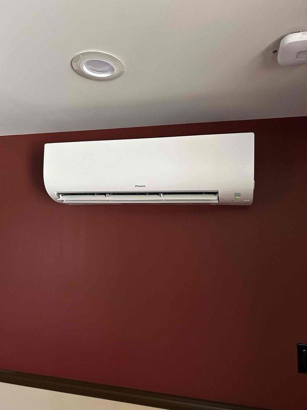 Completed installation of ductless mini-split HVAC system including outdoor heat pump unit mounted on composite pad with proper refrigerant lineset connections and indoor wall-mounted air handler with integrated controls. Installed 50-amp electrical sub-panel to support system requirements and ensured all electrical connections meet code specifications. System tested and operational with proper airflow and temperature control verified.