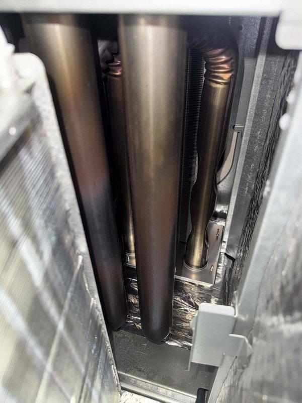Completed scheduled heating maintenance on HVAC system per contract fulfillment requirements. Performed comprehensive inspection of evaporator coil, refrigerant lines, and heat exchanger components; verified proper operation of all mechanical and electrical systems; documented unit condition with photographic records showing serpentine coil assembly, copper refrigerant lines with service ports, and interior components in satisfactory working order.