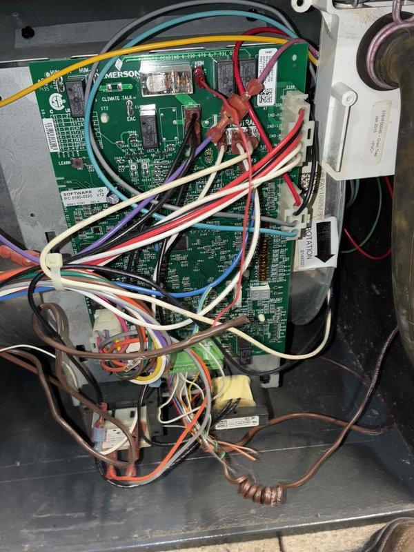 # HVAC Heating Maintenance Service

Completed scheduled preventive maintenance on residential furnace system as part of ongoing recurring service plan. Performed comprehensive system diagnostics including electrical testing of control board components using digital multimeter, verifying proper voltage readings and electrical continuity throughout the Emerson Climate Talk control system. Inspected all wire connections, terminal blocks, and safety circuits for secure connections and proper operation. Documented system conditions through photographic records showing control board assembly, wiring configurations, and measurement readings for service history files. All components tested within normal operating parameters with no deficiencies noted. System left in proper working condition and ready for continued heating season operation.