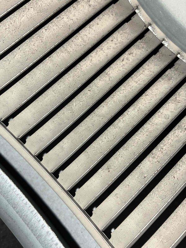 Completed scheduled heating maintenance inspection on HVAC system. Performed visual inspection of ductwork and air return components, documenting condition of return air grille which showed moderate dust accumulation on horizontal slats and surrounding ductwork. System operational and accessible for routine maintenance procedures.