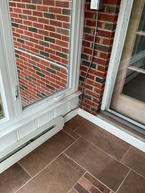 Installed two 6-foot BERKO electric baseboard heater kits with wall-mounted thermostat in three-season room. Ran new 30-amp circuit with double-pole breaker from garage panel through attic space, routing conduit down exterior brick wall to heating units. All electrical connections completed to code with one-year parts and labor warranty provided.