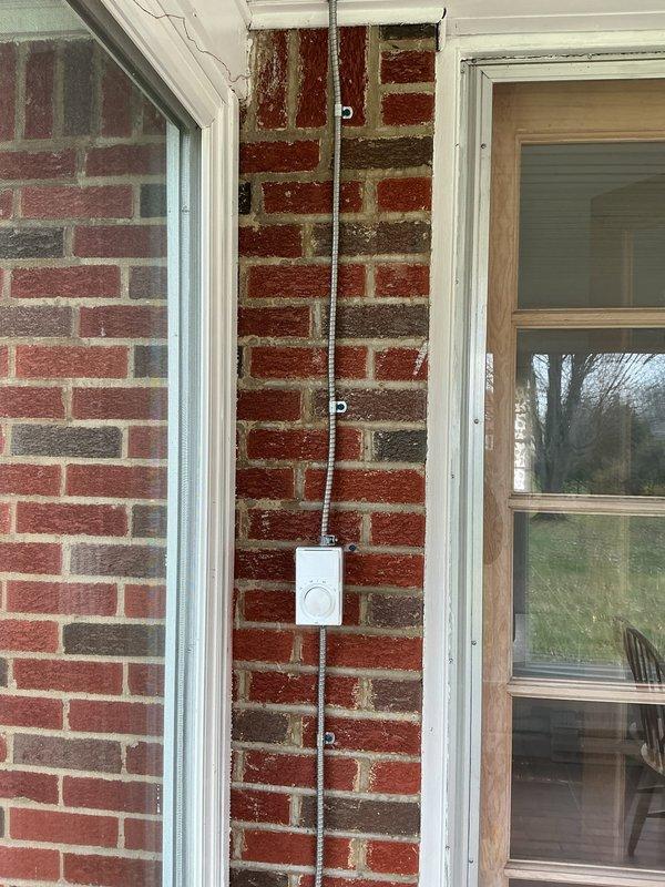 Installed two 6-foot BERKO electric baseboard heater kits with wall-mounted thermostat in three-season room. Ran new 30-amp circuit with double-pole breaker from garage panel through attic space, routing conduit down exterior brick wall to heating units. All electrical connections completed to code with one-year parts and labor warranty provided.