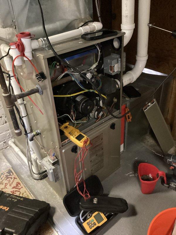 Completed scheduled heating maintenance on residential furnace system. Performed comprehensive system diagnostics using digital multimeter to verify electrical readings and component functionality. Inspected blower motor assembly, electrical connections, and all internal components with access panel removed. Verified proper operation of all safety controls and measured voltage levels throughout the system to ensure optimal performance and safe operation.