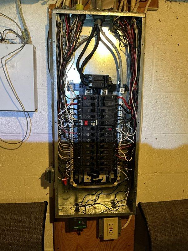 Completed electrical work associated with furnace installation, including circuit breaker panel modifications and low-voltage control wiring. Installed dedicated circuit protection in main electrical panel with appropriate wire routing and connections. Ran and terminated control wiring for furnace operation, including installation of control module with LED status indicators and GFCI-protected receptacle at equipment location. Verified proper grounding, secured all wiring connections, and confirmed system functionality with indicator lights showing active status.