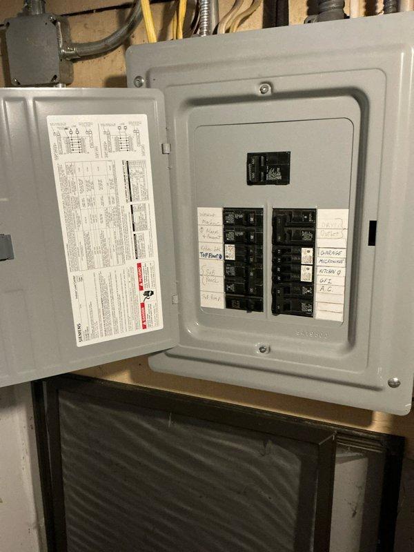 Conducted site assessment for HVAC system replacement options at residential property with existing air conditioning system that has been inoperative for extended period. Property currently utilizes boiler for heating needs. Inspected electrical panel to verify available circuit capacity and breaker configuration for potential new equipment installation. Evaluated attic space and existing ductwork infrastructure, noting flexible duct runs and current insulation conditions. Documented electrical service capacity, attic access, and existing HVAC components to provide comprehensive replacement system recommendations and installation specifications.