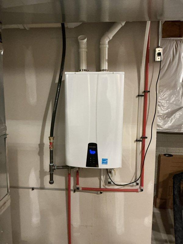# Tankless Water Heater Maintenance Service

Performed routine maintenance on a wall-mounted Navien tankless water heater unit. Conducted complete system flush to remove mineral buildup and sediment from the heat exchanger, inspected internal components including the blower assembly and heat exchanger fins, verified proper operation of all control systems and safety devices, and confirmed optimal performance of PEX plumbing connections and gas line installations.