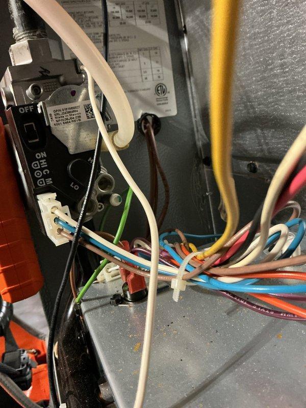 Completed routine heating maintenance inspection on residential HVAC system. Performed diagnostic testing using differential manometer to measure static pressure across air handler, recording reading of 1.79 inches water column to verify proper airflow and system performance. Inspected Aprilaire humidifier component for proper operation and integration with heating system. Verified all electrical connections, control wiring, and safety switches within unit compartment, confirming proper wire terminations and secure connections at terminal blocks. System operating within normal parameters with no deficiencies noted.