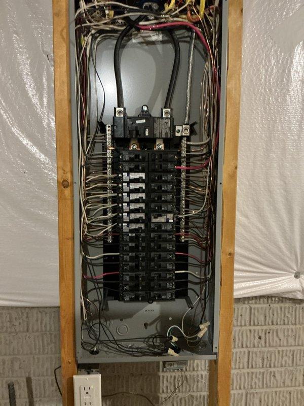 Responded to service call for main breaker repeatedly tripping under minimal electrical load. Upon inspection, found residential electrical panel experiencing nuisance tripping when multiple circuits were energized simultaneously. Performed thorough diagnostic testing of main breaker assembly and branch circuits. Inspected all wire connections at main lugs and verified proper torque specifications. Tested individual circuit breakers for proper operation and amperage ratings. Evaluated overall panel load distribution and identified potential overload conditions. Documented panel configuration showing dual-row breaker arrangement with main disconnect at top position. Verified all conductor terminations were secure and properly sized for their respective breaker ratings. Panel restoration completed with all circuits operational and load properly balanced across phases.