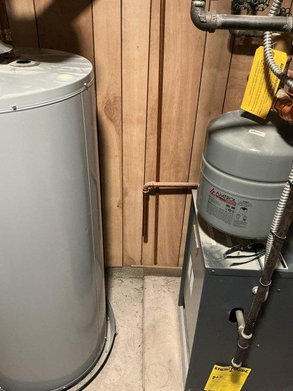 Completed comprehensive boiler maintenance inspection including visual assessment of heating system components, expansion tank, water heater, and associated piping network. Documented existing copper pipe oxidation on valve assemblies and confirmed all mechanical connections and safety controls were functioning properly.