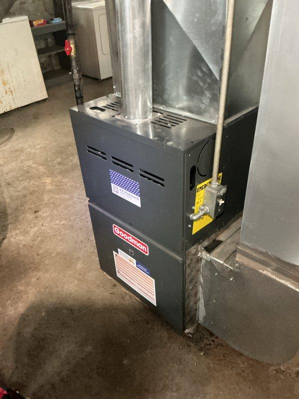 Completed scheduled heating maintenance on Goodman residential furnace system. Performed comprehensive inspection of unit operation, verified proper airflow through ductwork connections, checked all safety labels and indicators for compliance, and confirmed system functionality with illuminated control panel displaying normal operating status. All mechanical components, duct connections, and ventilation pathways were found to be in proper working order with no immediate service needs identified.