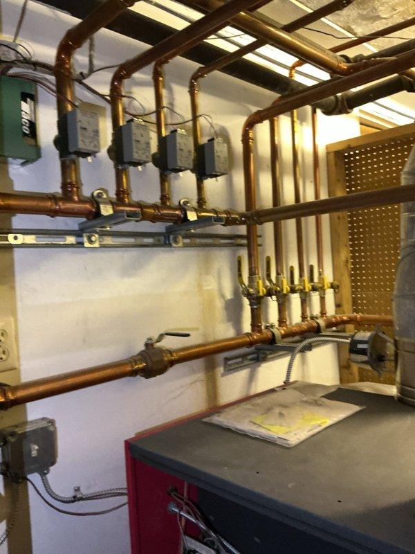 Completed comprehensive boiler maintenance inspection including examination of burner assembly, heat exchanger tubes, and hydronic distribution system. Verified proper operation of all zone circulators, control valves, and manifold connections throughout the copper piping network. All components found to be in satisfactory working condition with no immediate service requirements identified.