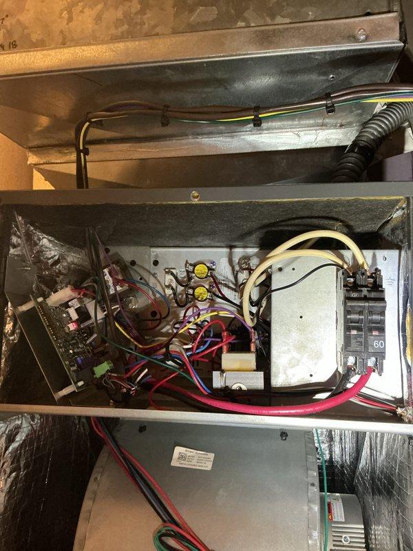 Completed comprehensive heating system maintenance inspection on residential HVAC unit. Performed thorough examination of electrical panel connections, verifying proper circuit breaker operation and wire terminations for the heating system. Inspected ceiling-mounted return air vent, ductwork insulation, and air handler plenum in utility area, confirming all components were properly secured and functioning correctly. All electrical connections, ductwork, and ventilation components found to be in good working order with no issues requiring immediate attention.