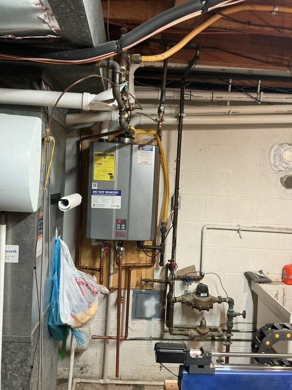 Performed routine maintenance on tankless water heater unit, including inspection of gas line connections, copper water supply lines, exhaust venting system, and electrical connections. Verified proper operation of all components, checked for any signs of corrosion or leaks, and confirmed unit specifications and warranty documentation were clearly visible and intact.