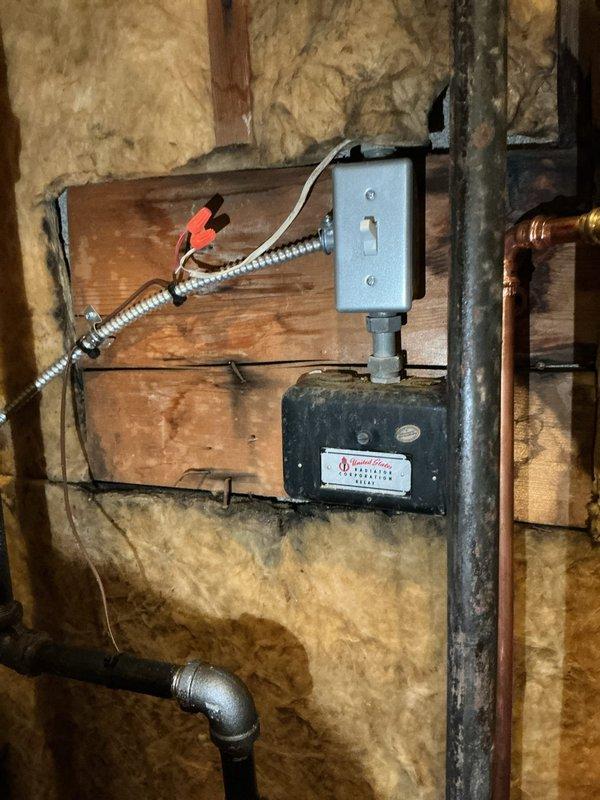 Completed first-year preventive maintenance on residential hot water boiler system. Performed comprehensive inspection of boiler unit, verified proper operation of all copper supply and return lines, tested blue-handled isolation valves for functionality, and confirmed secure mounting of all plumbing connections and brass fittings. Inspected sediment filter housing for debris accumulation, examined electrical components including junction box and circulator pump motor for proper operation, and verified all wiring connections were secure with no signs of overheating or damage.