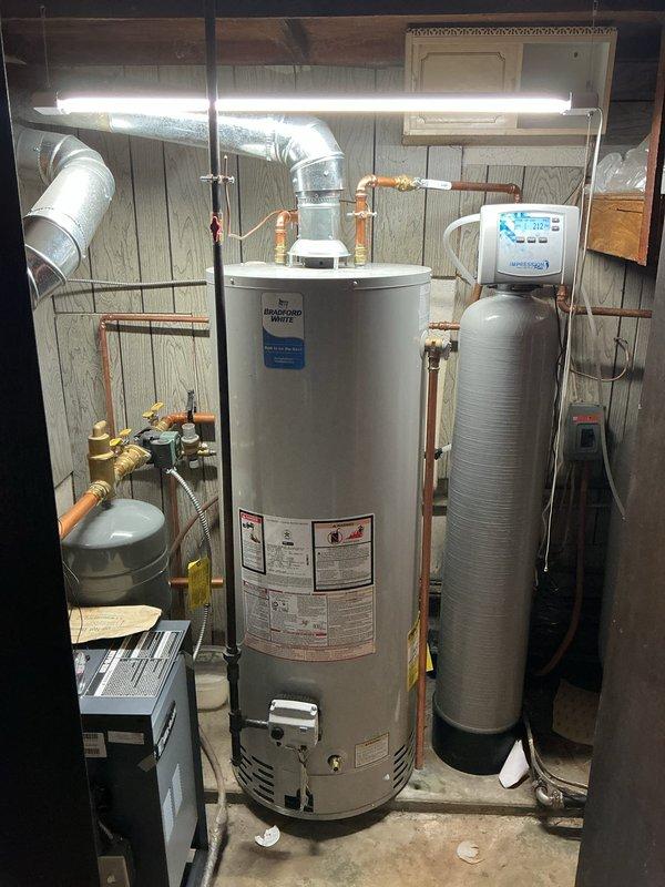 Performed annual preventative maintenance on Bradford White tanked water heater, including complete tank flush to remove sediment buildup and ensure optimal performance. Inspected all plumbing connections, pressure relief valve, and gas burner assembly, confirming proper operation with visible blue flame and adequate combustion. All components found in good working condition with no leaks detected.
