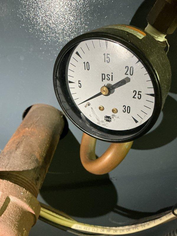 Completed scheduled preventive maintenance on water boiler heating system as part of ongoing recurring service plan. Inspected and verified proper operation of system pressure gauge reading approximately 20 PSI, pump control assembly with green indicator light showing active status, and associated valve components. All boiler components found operating within normal parameters with no immediate service needs identified.