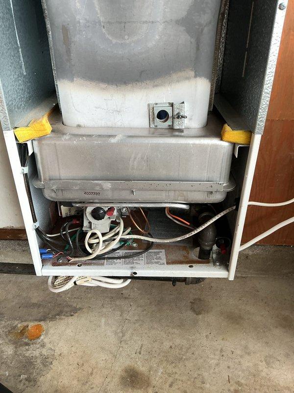 Completed routine heating maintenance on residential gas-fired water heater system. Performed visual inspection of all internal components, burner assembly, and heat exchanger. Verified proper flame characteristics and combustion through observation port, confirming normal orange-red flame pattern and burner operation. Inspected condensate collection tray, gas valve assembly, venting system, and all associated piping connections for signs of leaks or deterioration. All components found to be functioning within normal operating parameters at time of service.