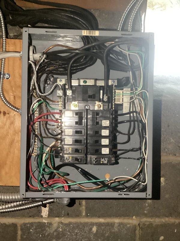 Conducted comprehensive electrical panel assessment for estimate purposes. Documented existing 200-amp main service panel installation, photographed internal breaker configuration showing dual-row circuit breaker arrangement with associated branch circuit wiring, and evaluated exterior meter base connection with PVC conduit routing along foundation. Assessed panel capacity, wiring conditions, and service entrance components to provide accurate replacement quotation.