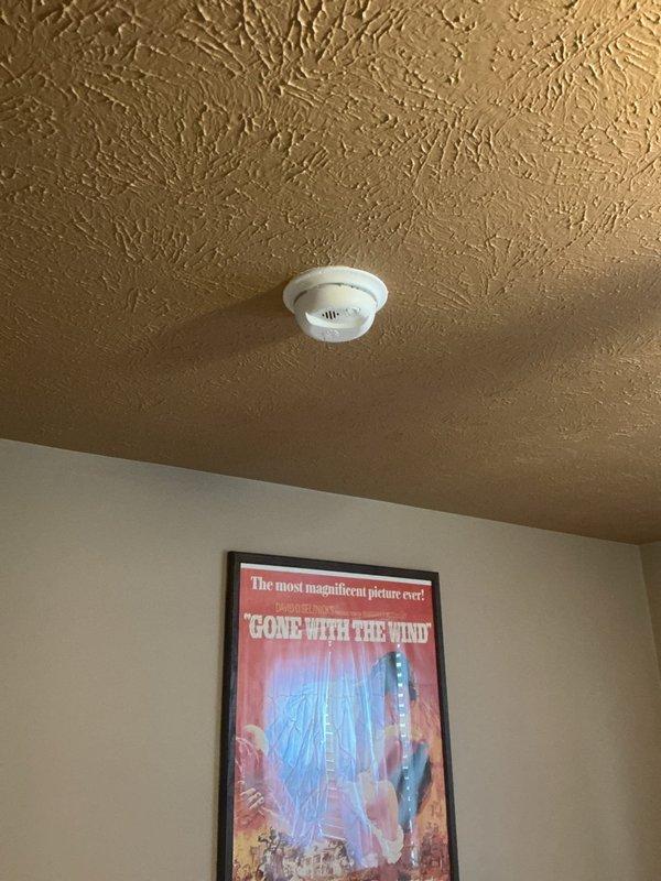 Installed new smoke and carbon monoxide detectors on residential ceiling. Mounted units securely to textured ceiling surface, verified proper operation of indicator lights, and confirmed devices were functioning correctly per manufacturer specifications.