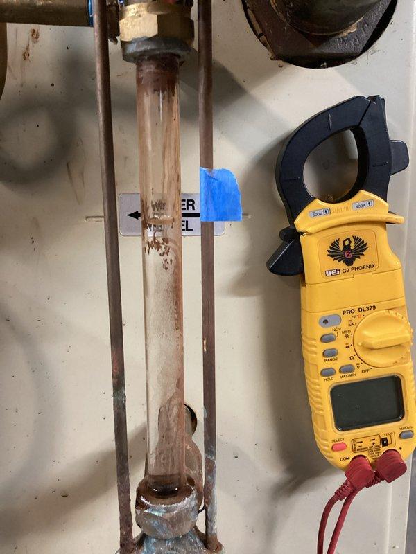 Completed scheduled HVAC heating maintenance on boiler system, performing comprehensive inspection of all components including piping, connections, and control systems. Documented system condition with diagnostic measurements using clamp meter, inspected sight glass showing sediment accumulation, and examined copper piping exhibiting corrosion and mineral deposits requiring monitoring. Verified all PVC piping, ball valves, and connections for proper operation and confirmed system functionality upon completion.