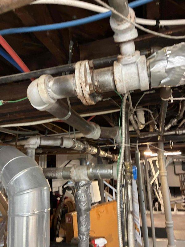 Completed scheduled HVAC heating maintenance on boiler system, performing comprehensive inspection of all components including piping, connections, and control systems. Documented system condition with diagnostic measurements using clamp meter, inspected sight glass showing sediment accumulation, and examined copper piping exhibiting corrosion and mineral deposits requiring monitoring. Verified all PVC piping, ball valves, and connections for proper operation and confirmed system functionality upon completion.