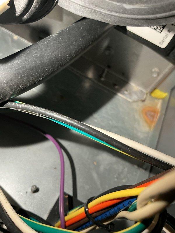 Completed scheduled heating maintenance on HVAC system. Performed comprehensive inspection of furnace unit, including examination of heat exchanger, burner assembly, and internal electrical components. Verified all wire connections were secure and properly routed throughout the equipment compartment. Inspected condensate drain system, noting PVC drainage piping and safety port valve in proper working condition. Observed evidence of mineral deposits and condensation staining on drain pan surface, typical of normal system operation. Checked insulation on refrigerant lines and condensate tubing for integrity. All system components found operating within manufacturer specifications with no immediate service requirements identified.