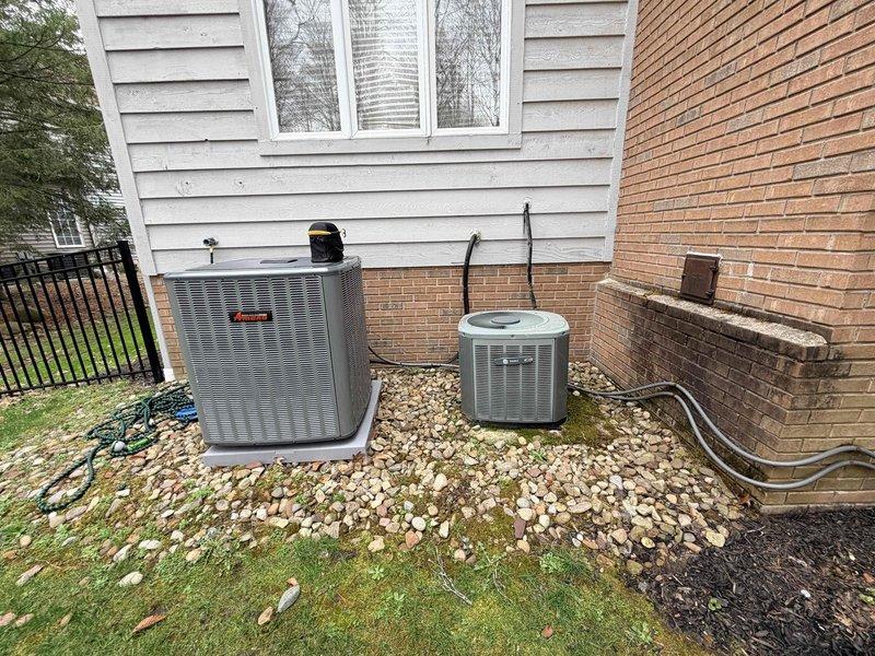 Responded to no-cooling call for two residential AC units—one approximately one month old and another 18-20 years old—both completely non-operational. Upon arrival, performed diagnostic assessment on both condenser units located in side yard installation area. Utilized electronic diagnostic equipment to test electrical components and refrigerant system parameters at service ports. Inspected copper refrigerant lines, service valves, and electrical connections on both units. Troubleshot power supply issues and system controls to identify root cause of simultaneous failure on both systems. Documented equipment conditions and diagnostic findings with photographic evidence for service records.