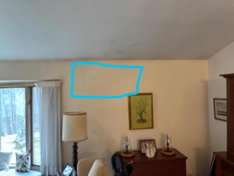 Conducted on-site evaluation for add-on mini split heat pump system installation in residential property. Assessed interior living room wall space and exterior foundation area to determine optimal placement for indoor air handler unit and outdoor condenser unit, with system intended for heating-only operation to supplement existing HVAC equipment.
