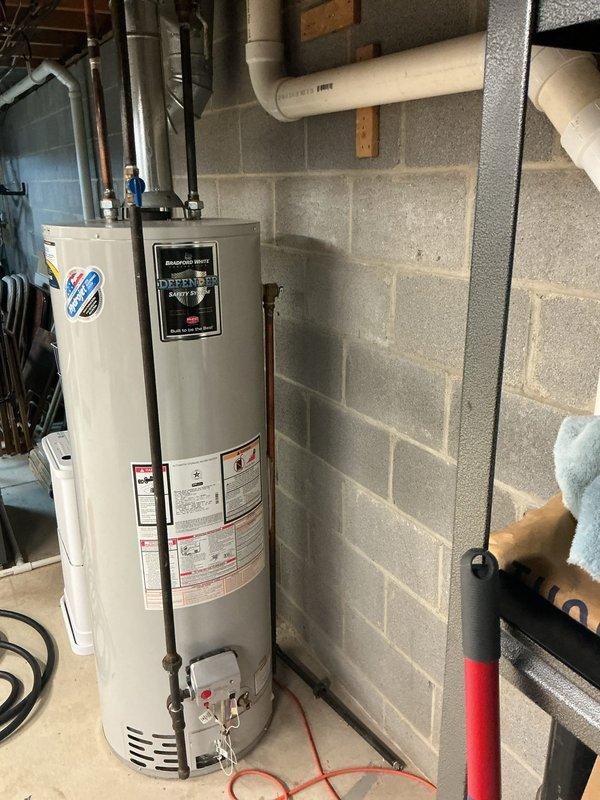 Performed routine maintenance on a Bradford White tanked water heater located in the basement utility area. Completed a full system flush to remove sediment buildup and maintain optimal heating efficiency. Inspected all plumbing connections, including copper supply lines and PVC drain piping. Verified proper operation of the pressure relief valve and confirmed system pressure readings on the gauge were within normal operating parameters. Examined the gas venting configuration and ensured all safety labels and manufacturer specifications were visible and intact. Unit is functioning properly with no leaks detected at connections or tank base.
