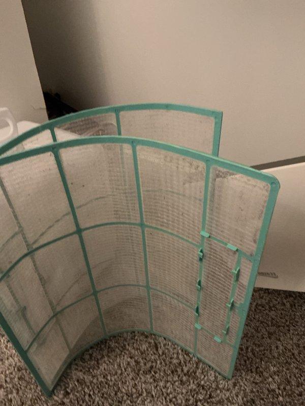 Performed preventative maintenance tune-up on wall-mounted mini split system. Opened unit housing to access evaporator coil assembly, inspected internal components including heat exchanger fins and wiring connections. Removed and cleaned two curved mesh filters that had accumulated significant dust and debris, restoring proper airflow to the system.