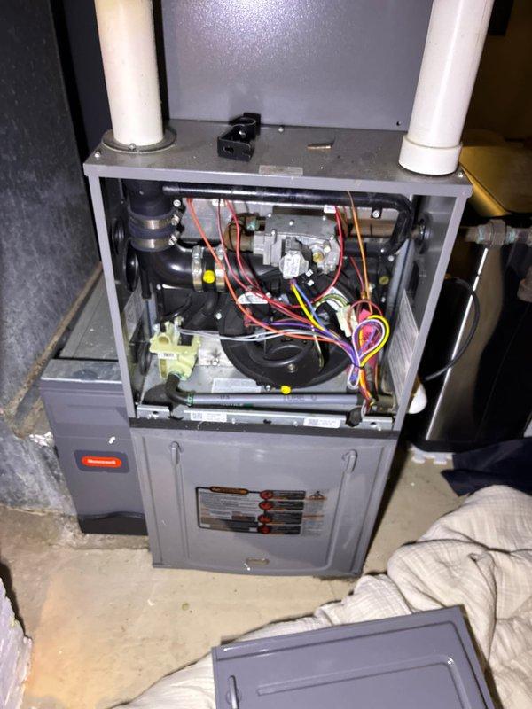 Conducted on-site evaluation of existing residential HVAC system per customer request for cooling system replacement estimate. Assessed current furnace and air conditioning equipment, documenting existing thermostat configuration and furnace installation with exposed internal components including blower motor assembly, gas valve connections, and control wiring. Provided comprehensive replacement options for complete system upgrade to address reported cooling system failure.