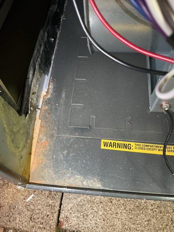 Responded to service call for water accumulation around furnace base. Upon arrival, found significant moisture pooled at equipment foundation. Conducted thorough inspection of furnace cabinet and surrounding area to identify water source. Examined condensate drain system, primary and secondary drain lines, evaporator coil pan, and all connection points for potential leaks or blockages. Checked furnace heat exchanger for cracks or failures that could produce condensation issues. Inspected humidifier connections if applicable. Verified proper drainage slope and confirmed drain line termination points. Assessed cabinet integrity for rust, corrosion, or panel seal failures allowing moisture intrusion. Documented conditions with photographic evidence showing equipment compartment and surrounding floor area affected by water damage. Advised customer of findings and recommended corrective action to resolve moisture issue and prevent future water accumulation.