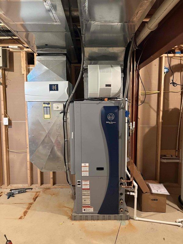 Completed installation of Water Furnace geothermal heat pump system model WSAV072BD1A12C1L2B in basement mechanical room. Unit was installed with integrated humidifier, connected to ground loop system, and all electrical connections completed per manufacturer specifications at 208-230V service. System is operational and awaiting line bleeding by drilling company to finalize ground loop commissioning.