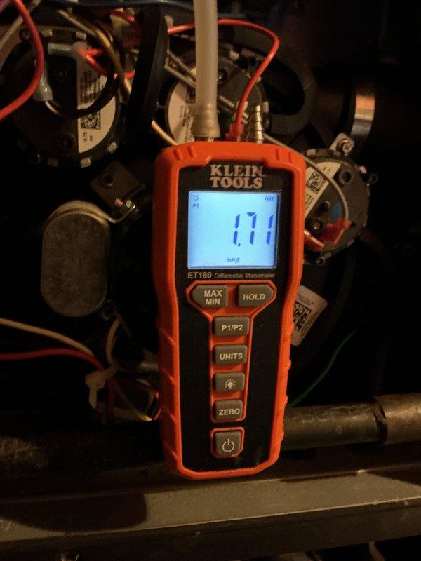 Completed scheduled heating maintenance on residential forced-air furnace system located in basement utility area. Performed comprehensive inspection of air handler unit, verifying proper operation of all mechanical components including blower motor assembly and electrical connections. Utilized Klein Tools ET160 manometer to measure static pressure, recording reading of 171 inches of water column to assess system airflow and performance. Inspected ductwork, verified secure mounting of control panels, and confirmed all safety systems functioning within normal parameters. Unit operating efficiently with no issues identified during maintenance visit.