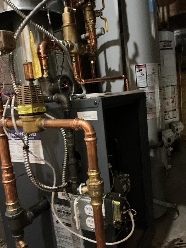 Completed first-year preventive maintenance on residential hydronic boiler system. Performed comprehensive inspection of boiler unit, circulator pumps, expansion tank, copper piping, brass fittings, and all associated plumbing components. Verified proper operation of zone valves, checked system pressurization, inspected all connections for leaks, and confirmed adequate water flow throughout the heating system. All equipment found operating within normal parameters with no immediate concerns identified.