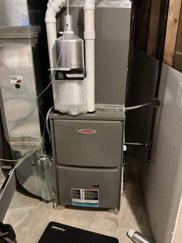 # HVAC Heating Maintenance Completed

Performed comprehensive heating maintenance on a residential Lennox furnace system located in basement mechanical room. Conducted thorough inspection of all furnace components, including burner assembly, heat exchanger, blower motor, and control board. Verified proper operation of safety switches and tested ON/OFF functionality of control module. Inspected electrical connections throughout the system, including multiple wire harnesses and connectors, confirming all connections were secure and free from signs of wear or damage. Examined internal mechanical components and housing for proper operation and structural integrity. Checked PVC venting system and associated piping for proper installation and clearances. Inspected integrated humidifier system mounted in supply piping, verifying filter media condition and proper water flow. Verified flexible conduit connections between furnace and other equipment were secure. All components found to be in goo