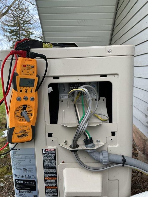 Completed first-year heating maintenance on a Daikin ductless heat pump system. Performed diagnostic testing on the outdoor condensing unit using digital multimeter to verify electrical connections and component operation, inspected indoor wall-mounted air handler for proper function, and confirmed system operational status with no issues found.