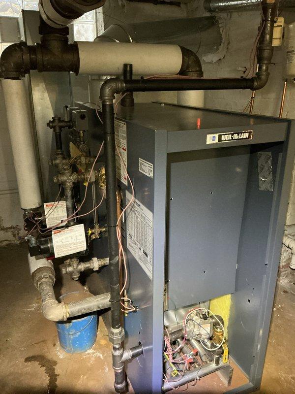 Performed routine preventative maintenance on Weil-McLain boiler system in basement mechanical room. Conducted thorough inspection of boiler components, burner assembly, gas connections, electrical wiring, and associated piping systems including expansion tank and circulation components. Cleaned and serviced internal mechanisms with unit access panel removed for complete system evaluation. All equipment found operating within normal parameters with no immediate repairs required.