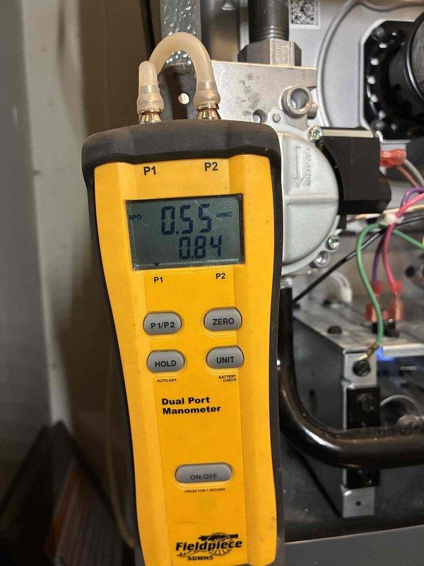 Completed full HVAC system installation including 80% efficiency gas furnace and air conditioning unit. Installed new Goodman outdoor condensing unit on concrete pad with proper clearances from structure and fencing. Mounted unit includes appropriate electrical disconnect and line set connections. Interior furnace installation completed with gas valve assembly, control wiring, and all necessary safety controls properly connected and secured. Performed system startup and commissioning procedures, including pressure testing with dual-port manometer to verify proper gas pressure readings at furnace inlet and outlet ports. All electrical connections, refrigerant lines, and condensate drainage installed per manufacturer specifications. System tested and operational, ready for service.