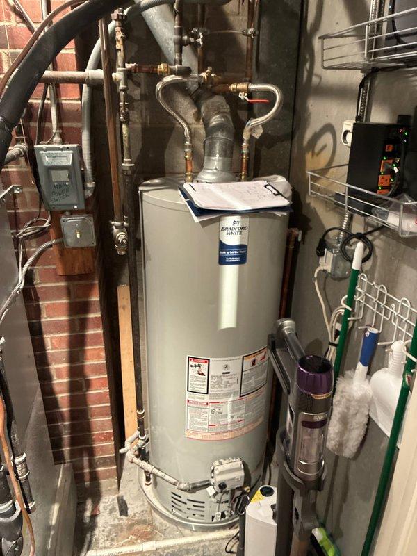 Conducted comprehensive site assessment for full HVAC system replacement at residential property with rooftop unit configuration. Evaluated existing mechanical equipment in basement utility area, including water heater, furnace connections, and associated plumbing infrastructure. Documented current system layout featuring exposed brick wall-mounted components, copper piping configurations, gas lines, and electrical panels. Assessed rooftop unit accessibility via walk-out access point, confirming straightforward installation conditions. Provided customer with multiple full system replacement options based on existing equipment age, current configuration, and ease of access for equipment changeout.