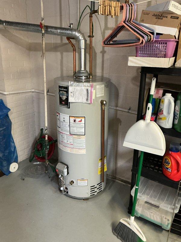 Performed routine maintenance flush on residential tanked water heater to remove sediment buildup and ensure optimal performance. Drained unit completely through bottom drain valve into utility sink, cleared accumulated mineral deposits, refilled system, and verified proper operation of all components including temperature/pressure relief valve and heating elements.
