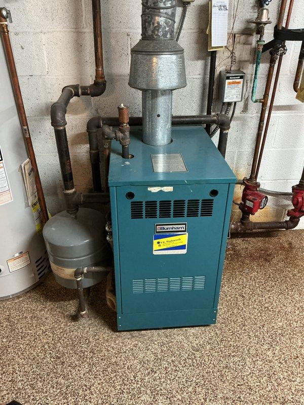 Completed scheduled maintenance on residential Burnham hydronic boiler system. Performed comprehensive inspection of boiler unit, flue piping, expansion tank, circulation components, and associated copper piping throughout the heating system. All equipment found operating within normal parameters with proper venting and no visible leaks detected.