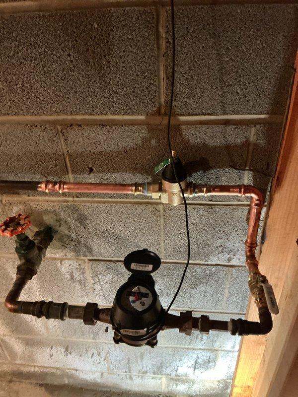 Installed new ST5 thermal expansion tank and pressure regulating valve on the domestic water system. The installation included proper mounting to the wall, connection to the existing copper piping, and verification of system pressure at 80 PSI using the integrated gauge.