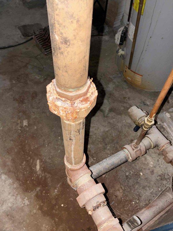 Completed comprehensive boiler maintenance inspection and documentation. Examined and photographed key system components including Honeywell control unit, water level indicators, supply and return piping, isolation valves, and associated mechanical connections. Documented significant corrosion present on vertical drainage piping and coupling joints, noting heavy rust accumulation and mineral deposits that may require future attention to prevent system integrity issues.