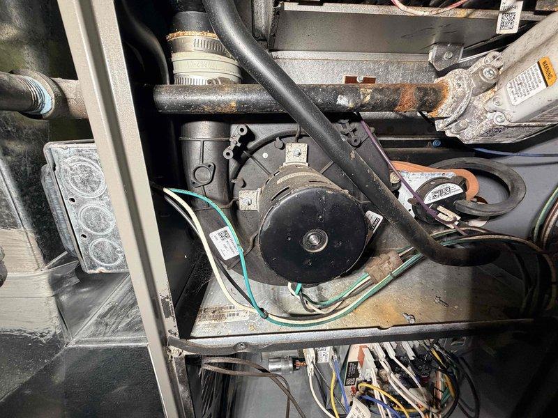 Completed MVP Heating Maintenance on residential heating system. Performed comprehensive inspection of outdoor unit components, including electrical terminal connections, condenser assembly, and compressor motor. Documented existing conditions showing moderate corrosion on mounting brackets and terminal hardware, with all electrical connections secure and operational. Verified proper wiring connections including ground conductors, inspected refrigerant lines and insulation integrity, and confirmed compressor motor operation. System operating within normal parameters at time of service completion.