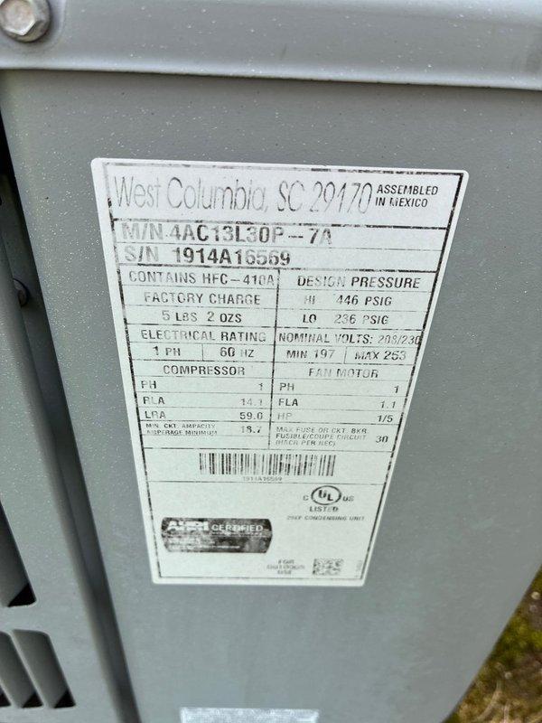 Performed comprehensive assessment of existing HVAC system for full replacement estimate. Documented current equipment configuration including 3-ton Goodman condensing unit (Model 4AC13L30P-7A) charged with R-410A refrigerant, gas furnace with air handler, and integrated water heater installation in utility closet. Photographed manufacturer data plates showing electrical specifications of 208/230V single-phase operation and equipment serial numbers for replacement planning. Evaluated cramped mechanical room layout with vertically stacked components to determine optimal replacement equipment sizing and installation approach for complete system upgrade.