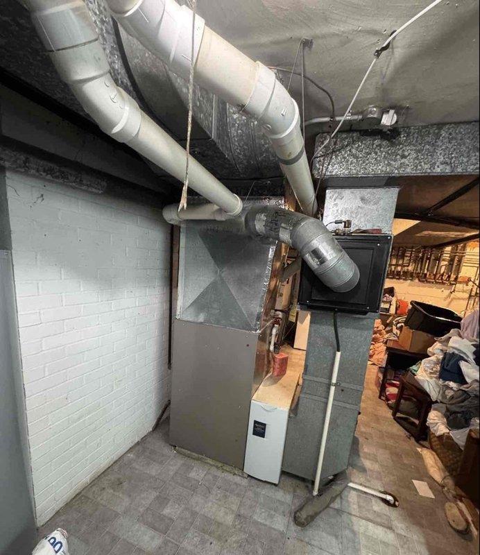 Completed full HVAC system replacement in basement mechanical room with straightforward access. Installed new furnace/air handler unit with associated white PVC ductwork properly secured to ceiling joists, ensuring proper ventilation and system operation. All equipment tested and verified functioning to manufacturer specifications.