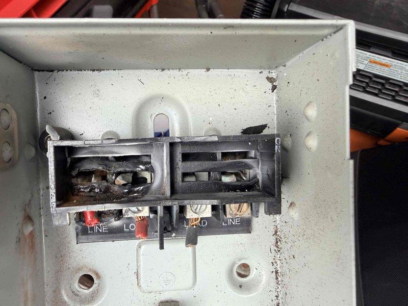 Responded to no cooling call following electrical panel repairs by third-party electrician after generator-related power surge. Upon arrival, confirmed heating operation was normal but air conditioning system would not engage at thermostat. Inspected outdoor unit disconnect and found severe heat damage to terminal block with melted plastic housing and distorted connections. Terminal block showed evidence of electrical overheating, likely caused by loose connections or compromised wiring during the electrical event that damaged the panel. Documented damaged disconnect components with photographs showing burned terminals and deteriorated wire connections. Advised customer that the AC disconnect requires immediate replacement due to safety hazard and that damaged terminals prevented proper power delivery to condensing unit, explaining why the air conditioning system would not activate despite thermostat calls for cooling.